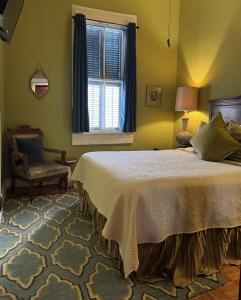 a bedroom with a bed and a chair and a window at The Dragonfly Tremé-Historic Guesthouse-Near French Quarter in New Orleans +152 photos