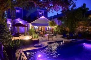 a backyard with a swimming pool at night at The Dragonfly Tremé-Historic Guesthouse-Near French Quarter in New Orleans