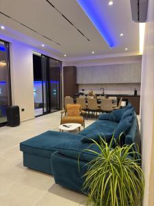 a living room with a blue couch and a table at Mia Villa in Draç