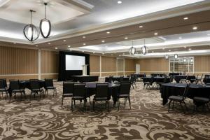 a conference room with tables and chairs and a podium at Sheraton Charlotte Hotel in Charlotte +48 photos