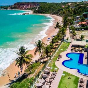 an aerial view of a beach with palm trees and the ocean at Flat Gold Sea View - Tabatinga Beach in Conde