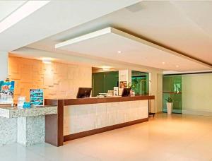 a lobby with a reception desk in a building at Flat Gold Sea View - Tabatinga Beach in Conde +37 photos