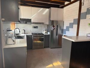 a kitchen with stainless steel appliances in a room at Casa acogedora y espaciosa in Huamboya