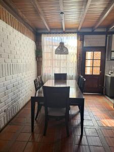 a dining room with a table and chairs at Casa acogedora y espaciosa in Huamboya +8 photos