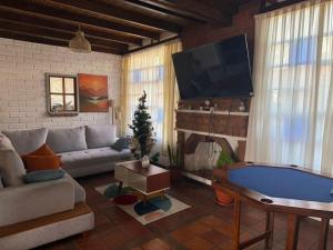 a living room with a couch and a tv at Casa acogedora y espaciosa in Huamboya