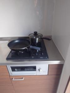 a pan sitting on top of a stove in a kitchen at ペンションsakuraRIGHT in Motobu +7 photos