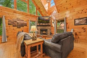 a living room with a couch and a fireplace in a cabin at A Bear's view in Sevierville