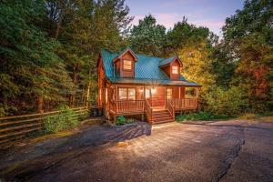 a cabin in the woods with a blue roof at A Bear's view in Sevierville