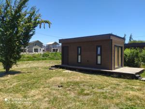 a small house in a field with a tree at TINY HOUSE Los Angeles in Los Ángeles