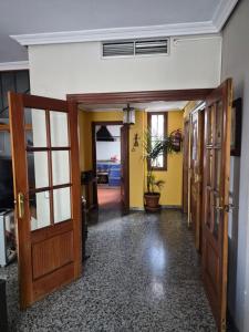 an empty hallway with doors and a potted plant at Casa Turistica Termas aparcamiento y desayuno incluido in Mérida