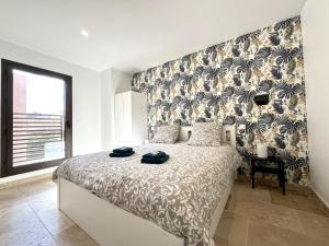 a bedroom with a bed and a large window at Résidence Le Jardin d'Eugénie in Sanary-sur-Mer +25 photos