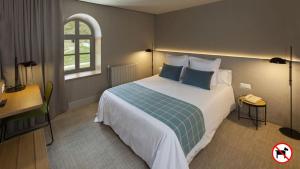 a bedroom with a large bed and a window at Hotel Vall de Núria in Queralbs +110 photos