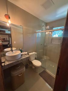 a bathroom with a toilet and a sink and a shower at Casa Recanto das arvores in Itacaré +34 photos