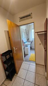 a room with a door and a kitchen with a sink at Holiday Everyday in Hemer in Hemer