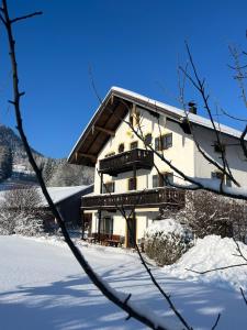 a building in the snow with snow covered ground at Maiergschwendter-Hof inkl. Chiemgaukarte in Ruhpolding