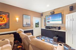 a living room with two couches and a flat screen tv at 8046 - Sun Runner in Rodanthe