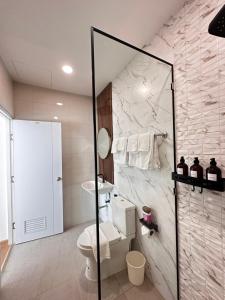 a bathroom with a toilet and a shower at Patong Relax Home in Patong Beach +20 photos