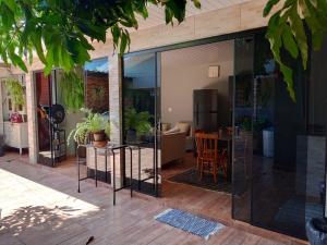 a living room with glass doors and a kitchen at Studio Carimã Foz in Foz do Iguaçu