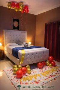 a bedroom with a bed with balloons on the floor at Azure palms hideaway in Kingston
