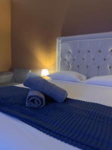 a blue rolled up towel on a bed at Azure palms hideaway in Kingston