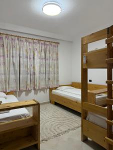 a room with two bunk beds and a window at Casa Shpresë - The Traditional Suite in Tirana