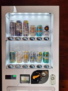 a refrigerator filled with lots of cans of soda at 和朗庵 in Matō