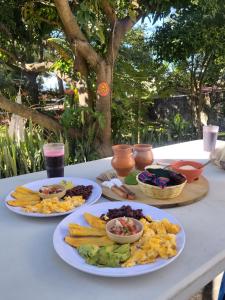 a table with three plates of food on it at Nawal Hostel in Santa Cruz La Laguna