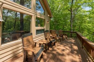 a deck with chairs and windows on a house at Happy Times by Railey Vacations in Swanton