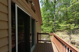 a porch of a house with a sliding glass door at Happy Times by Railey Vacations in Swanton