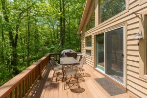 a wooden deck with a table and chairs on it at Happy Times by Railey Vacations in Swanton