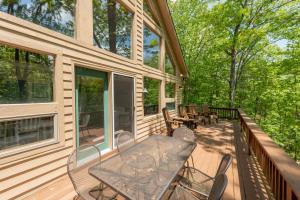 a screened porch with a table and chairs on it at Happy Times by Railey Vacations in Swanton