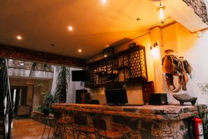 a bar in a room with chairs and atainment at Hotel Boutique in Querétaro