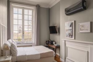 a bedroom with a bed and a window at Hotel Ô Château in Hayange