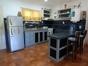 a kitchen with a refrigerator and a counter top at La Morada de sus Sueños Caeiro in Bialet Massé
