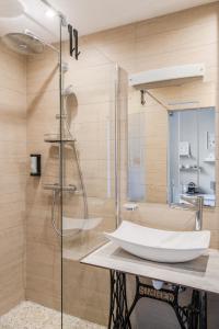 a bathroom with a sink and a shower at Hotel Ô Château in Hayange +101 photos