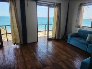 a living room with a view of the ocean at Departamento 1 dormitorio in Máncora +26 photos
