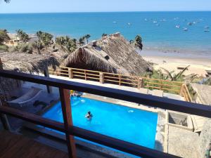 a person in a swimming pool next to a beach at Departamento 1 dormitorio in Máncora