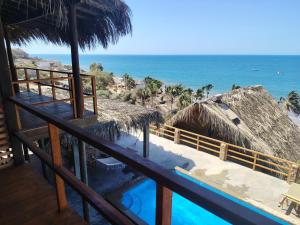 a view of the ocean from a resort with a swimming pool at Departamento 1 dormitorio in Máncora