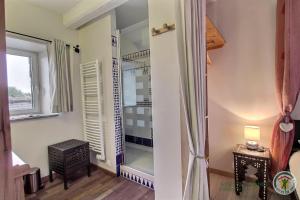 a room with a closet with a table and a window at Le gite riad de kerity in Paimpol +50 photos
