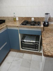 a kitchen with a stove and a counter top at Ed.fragatas residence in Bertioga