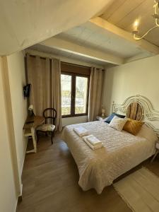a bedroom with a bed and a desk and a window at Casa Rural Belladona in Valdeprados +41 photos
