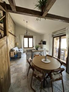 a living room with a table and a couch at Casa Rural Belladona in Valdeprados
