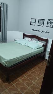 a bed sitting in a room with at Recanto do mar in Caraguatatuba +8 photos