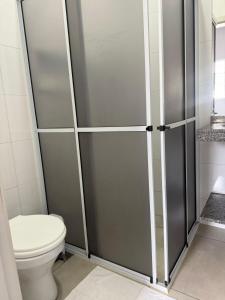 a bathroom with a toilet and a shower stall at Amazon LOFT 08 in Sorriso