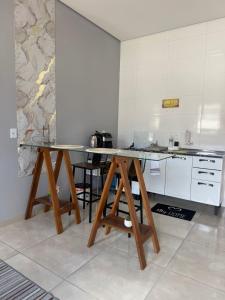 a kitchen with a wooden table in a room at Amazon LOFT 08 in Sorriso +6 photos