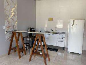 a kitchen with a counter and a refrigerator at Amazon LOFT 08 in Sorriso