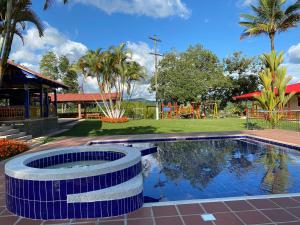 a pool at a resort with a playground at Hotel Campestre San Fernando in La Paloma
