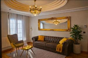 a living room with a couch and a mirror at Suite Legio VII in León