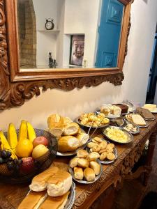a table topped with lots of different types of food at Hari Eco Pousada in Brumadinho +39 photos