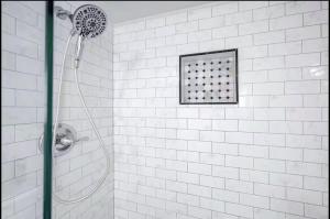 a shower with a shower head in a bathroom at Peaceful Private Cottage, Walk to Park & 5 Mins to Downtown in Nashville +24 photos